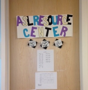 Door with colorful sign reading 'ASL Resource Center'
